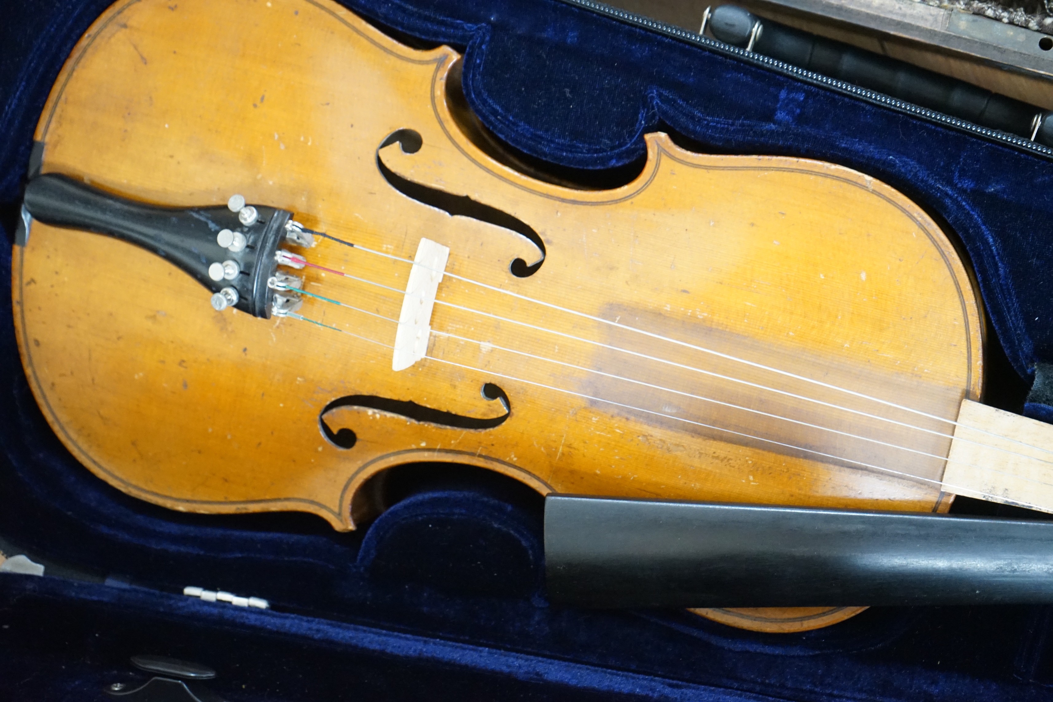 Two cased unnamed violins